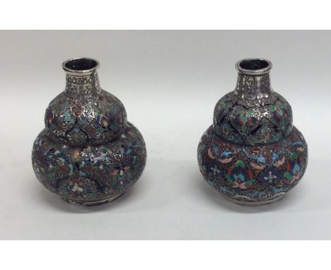 A good pair of Continental silver and enamel baluster shaped vases decorated in bright colours. Approx. 131 grams. Est. £200 