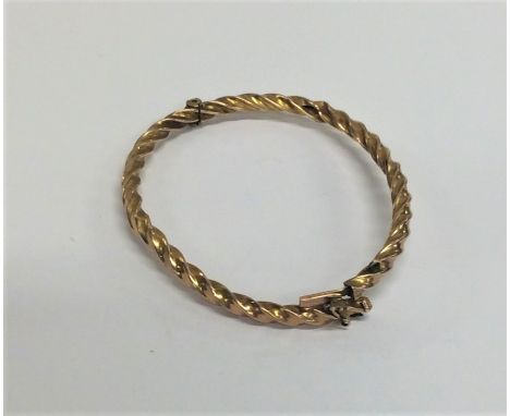 A 9 carat twist bangle with concealed clasp. Approx. 4.6 grams. Est. £50 - £80.