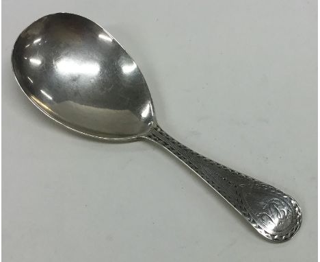 A Georgian silver bright cut caddy spoon decorated with wrigglework. Approx. 8.5 grams. Est. £40 - £60.