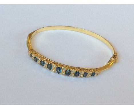 An 18 carat diamond mounted hinged bangle with concealed clasp and claw mounts. Approx. 17.2 grams. Est. £250 - £350.