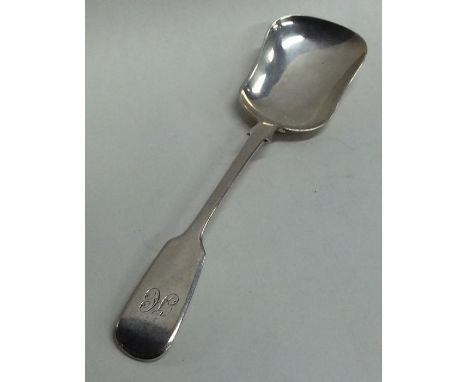 EXETER: A large silver fiddle pattern caddy scoop. By JW. Approx. 17 grams. Est. £20 - £30.