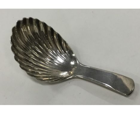 A good Georgian silver caddy spoon with fluted bowl. London. By JS. Approx. 10.8 grams. Est. £40 - £60.