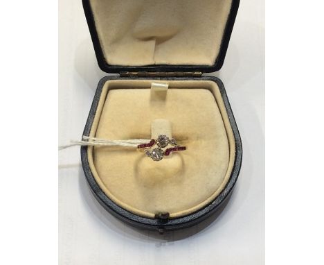 An attractive ruby and diamond crossover ring set in 18 carat gold and platinum claw mount. Approx. 2.7 grams. Est. £450 - £5