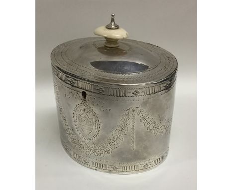 A good Georgian silver bright cut oval tea caddy with hinged top complete with key and locking mechanism. London 1784. By JL.