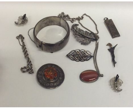 A bag containing a heavy silver bangle, ingot etc. Approx. 122 grams. Est. £30 - £40.