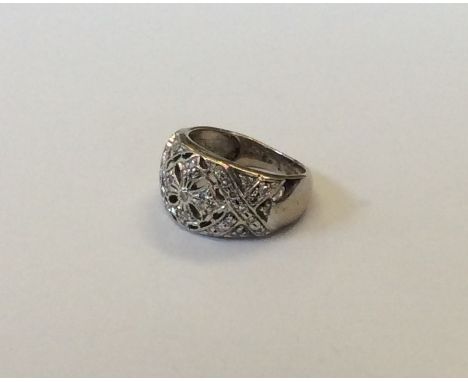 A 9 carat diamond and white gold modernistic cluster ring. Approx. 5.4 grams. Est. £60 - £80.