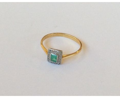 An attractive 18 carat and platinum emerald and diamond cluster ring. Approx. 3 grams. Est. £80 - £120.