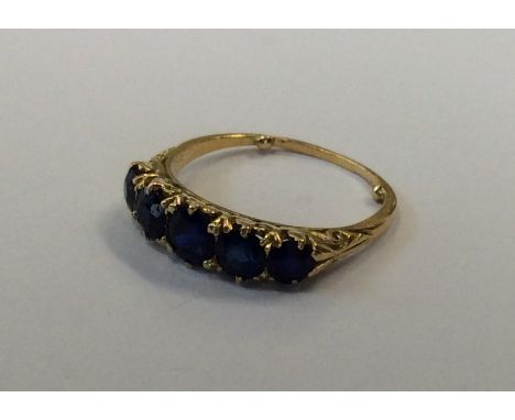 A sapphire five stone half hoop ring in 18 carat mount. Approx. 4 grams. Est. £400 - £800.