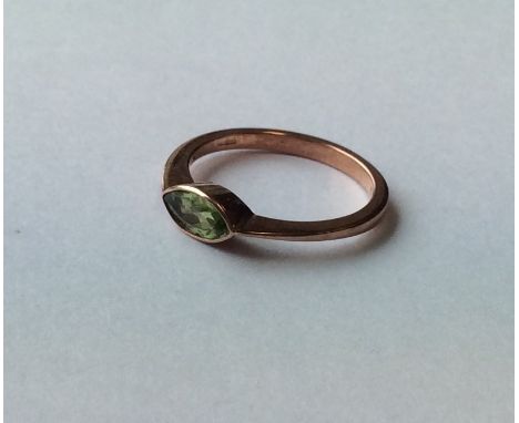 A marquise shaped peridot single stone ring in 9 carat mount. Approx. 2 grams. Est. £20 - £30.