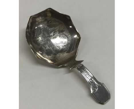 A good large Georgian silver bright cut caddy spoon decorated with flowers and leaves. Approx. 11.5 grams. Est. £50 - £80.