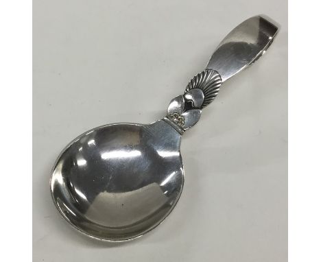 GEORG JENSEN: An unusual silver caddy spoon of typical design. Approx. 26 grams. Est. £50 - £80.