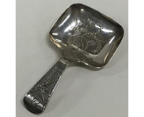 A Georgian silver bright cut caddy spoon decorated with flowers and leaves. London. By CB. Approx. 7 grams. Est. £30 - £40.