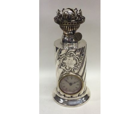 An unusual silver lamp mounted with a clock with swirl decoration. Sheffield. By JD&amp;WD. Approx. 818 grams. Est. £250 - £3