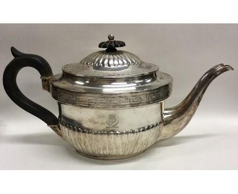 A Georgian silver half fluted teapot decorated with Greek key pattern. London. By JS. Approx. 504 grams. Est. £200 - £300.