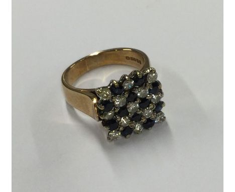 A large sapphire and diamond chequerboard ring in rose gold claw mount. Approx. 8 grams. Est. £80 - £120.