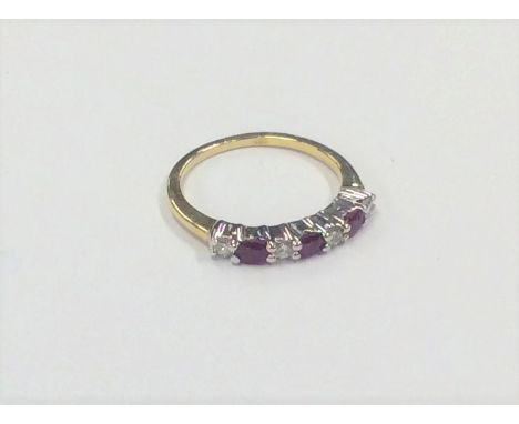 A ruby and diamond seven stone ring in 18 carat mount. Approx. 2.5 grams. Est. £50 - £80.