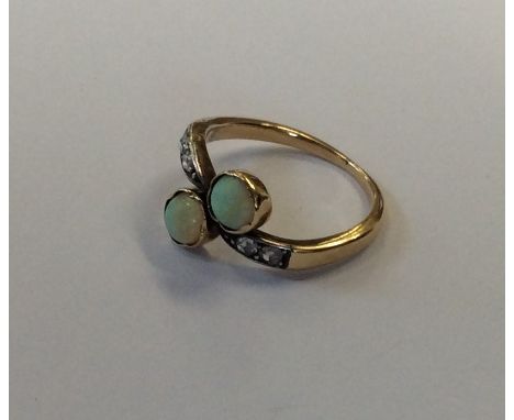 An opal and rose diamond two stone crossover ring. Approx. 3 grams. Est. £60 - £80.