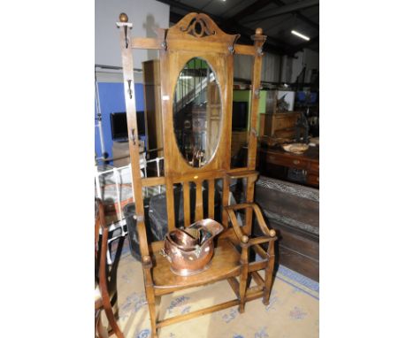 Edwardian oak hall stand with central bevelled edged mirror panel with bench seat and stick stand