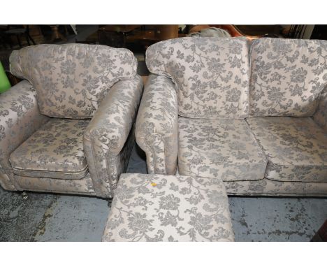 Contempory three piece suite comprising two seat sofa and matching armchair and footstool (less than one year old)