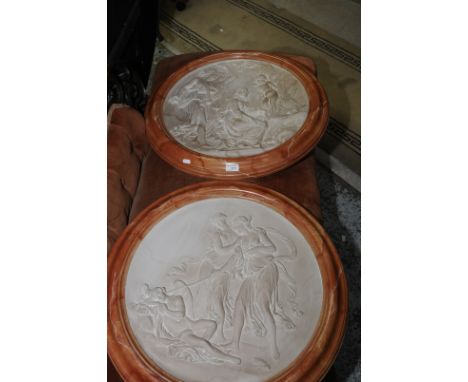 Pair of wall mounted framed ceramic panels depicting classical scenes 