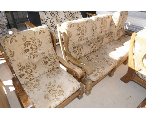 Three piece oak colonial style suite comprising of three seat sofa and two matching armchairs