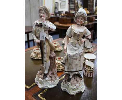 A PAIR OF CONTINENTAL FIGURES OF GARDENERS, the gentleman holding a spade, the lady a basket, 49cm high