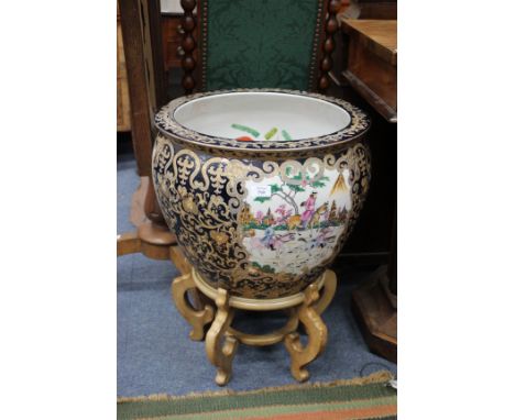 A LARGE ORIENTAL PORCELAIN FISH BOWL, the interior decorated with goldfish, the exterior of blue ground with scrolling gilt d