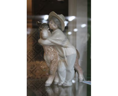 A LLADRO PORCELAIN FIGURAL GROUP OF A CHILD AND A YOUNG DONKEY, marked beneath, 21cm high