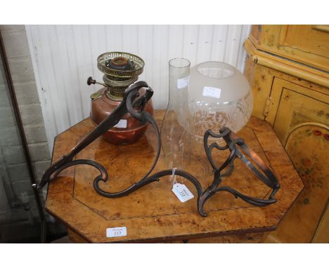 A HINKS PATENT ART NOUVEAU WROUGHT METAL OIL LAMP WALL BRACKET, 37cm high together with an associated oil lamp with copper re