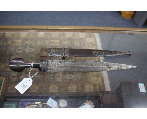 A MIDDLE EASTERN, POSSIBLY INDIAN, SHORT SWORD OR DAGGER with horn grip and white metal mounts and with a double edged fuller