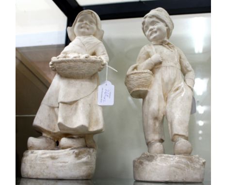 A PAIR OF PLASTER FIGURES one of a Dutch boy and the other of a Dutch girl, both wearing clogs 38.5cm high