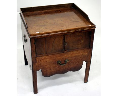 A COMMODE TABLE, the raised galleried top over two cupboard doors, commode drawer to the front and carrying handles to the si
