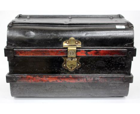 AN OLD BLACK PAINTED TIN LUGGAGE TRUNK with carrying handles to the side and brass hasp, 57cm wide