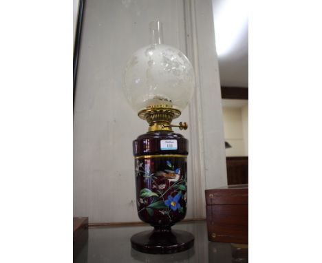 A 19TH CENTURY AMETHYST COLOURED GLASS OIL LAMP with coloured enamel decoration of a blue tit on a flower branch with Hinks &