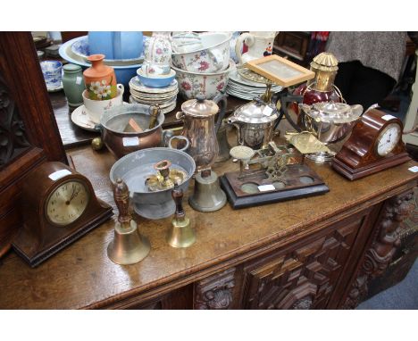 A SILVER PLATED TEA POT, two mantle clocks and a set of brass postal scales, two hand bells, a circular pierced brass trivet,