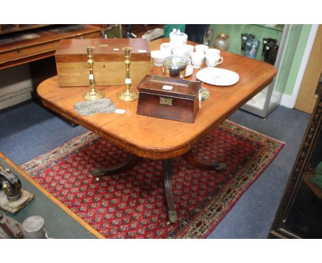 A 19TH CENTURY MAHOGANY TILT TOP DINING TABLE the rectangular top on turned column support and tripod base terminating in bra
