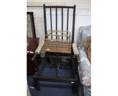 A VICTORIAN EBONISED BOBBIN TURNED OPEN ARMCHAIR, 62cm wide together with a brass framed magazine rack on tripod base (2)
