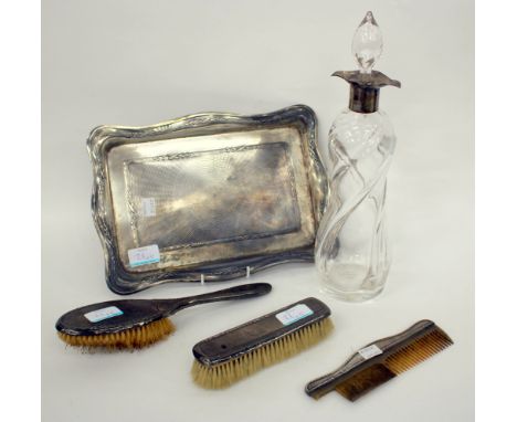 A SILVER MOUNTED DECANTER together with a silver rectangular dressing table tray with engine turned decoration, two brushes a