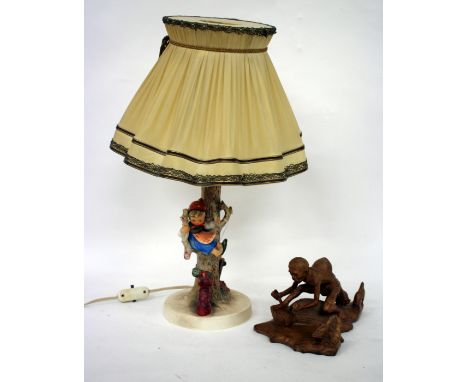 A GOEBEL POTTERY TABLE LAMP and an Oriental carved wooden figure (2)