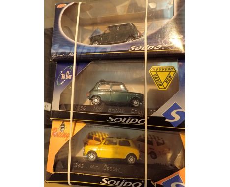 Three Solido 1/43 assorted diecast Mini Cooper model cars boxed