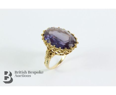 9ct yellow gold amethyst dress ring. The oval amethyst measuring 20 x 15mm, set in an ornate mount, London hallmark dated 197