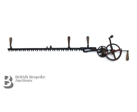 A circa 1920's hand crank rotary hedge trimmer, with four oak handles (one or two-man clipper) approx 155 cms in length (unbo