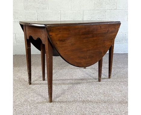 An 18th century style gate leg dining table, with an oval drop leaf top on six tapered legs