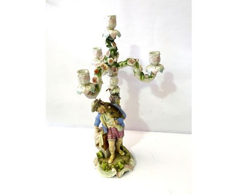 A Meissen style porcelain candelabrum, 19th century, the removeable candle arms on a pillar with figural supporters; also two