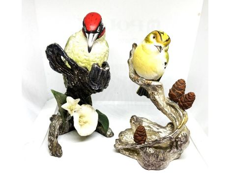 Two ceramic models of birds, 20th century, set on hallmarked silver bases, naturalistically modelled and decorated in colours