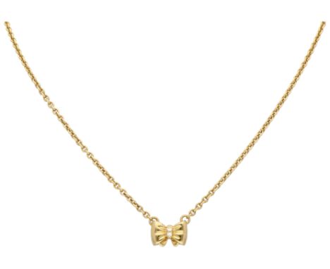 Chopard 18K yellow gold bow pendant on a necklace. Part of a demi-parure, see a pair of Chopard ear studs elsewhere in this a