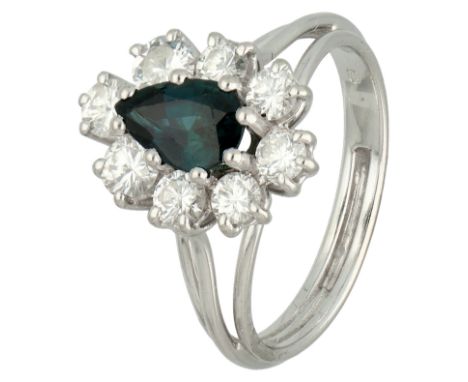 18K White gold entourage ring set with approx. 1.28 ct. diamond and synthetic sapphire. Set with a pear cut synthetic sapphir