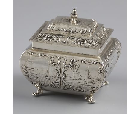 Tea caddy silver. Beautifully curved model with many scenes in relief showing boats and houses. Equipped with hinged lid. Net