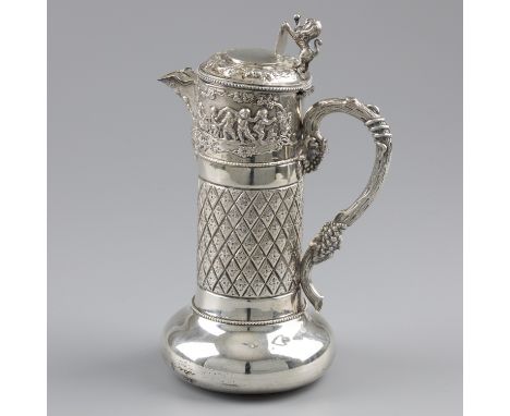 Large claret jug, silver. Large model executed with cherubs with instruments. The spout is decorated with playing cherubs abo