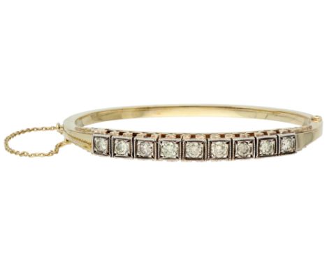 14K Yellow gold bangle bracelet set with approx. 1.15 ct diamond. Set with nine brilliant cut diamonds of approx. 1.15 ct. (S